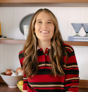 Woman wearing a red and black striped shirt in a kitchen setting