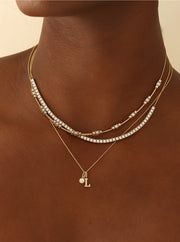 woman wearing gold and diamond necklaces
