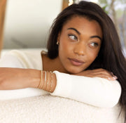 woman wearing gold bracelets
