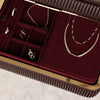 Jewelry set including necklaces and earrings displayed in a burgundy jewelry box.